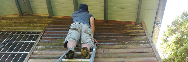 A worker applies sealant to the exterior of Mr. Lin's cabin