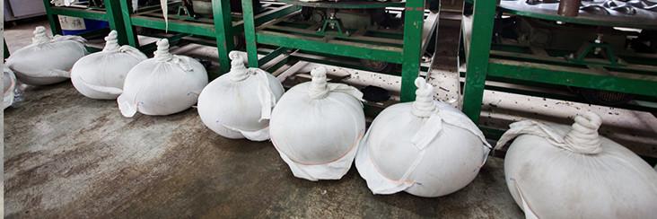 Tea leaves awaiting their turn in the ball rolling machine, one step out of many in making modern Oolong tea