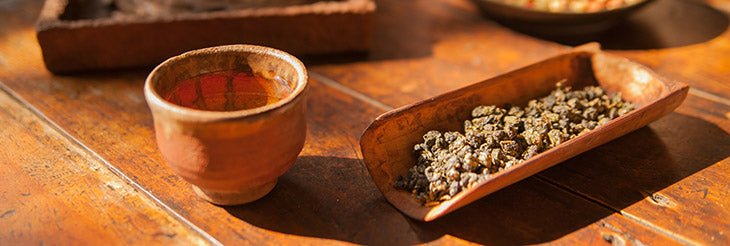 Loose leaf tea on a table with a cup