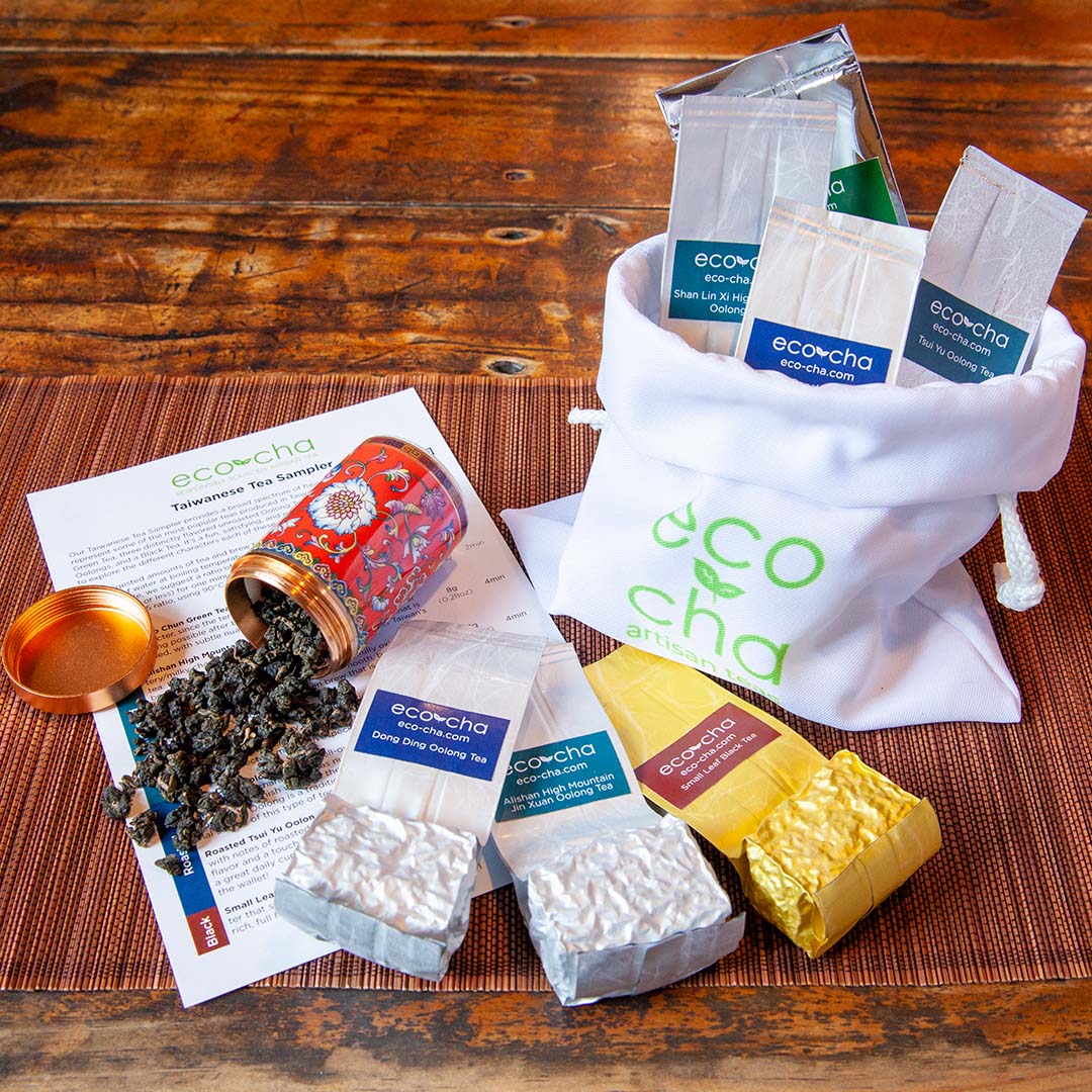 Taiwanese tea sampler - 7 tea samples in package alongside a white carry satchel. All on a nice wooden table.