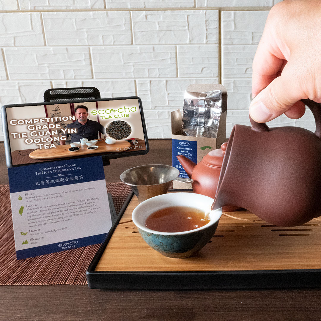 Eco-Cha Tea Club tea being poured into a cup with box of tea in background 