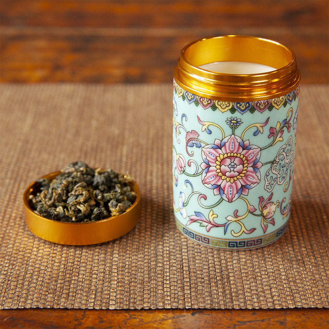 Yellow ceramic tea caddy with tea leaves in cap