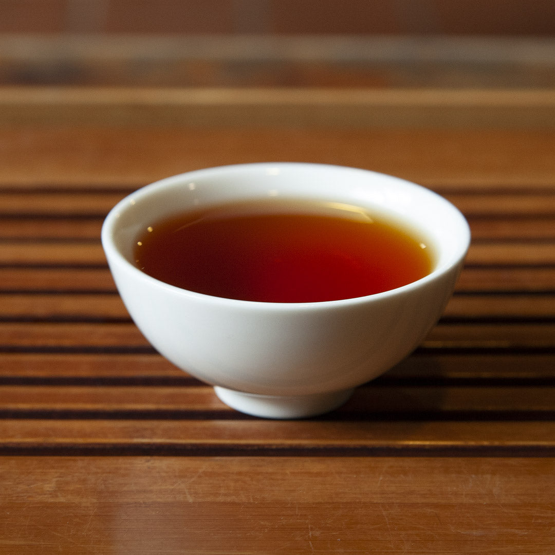 White porcelain tea cup full of tea