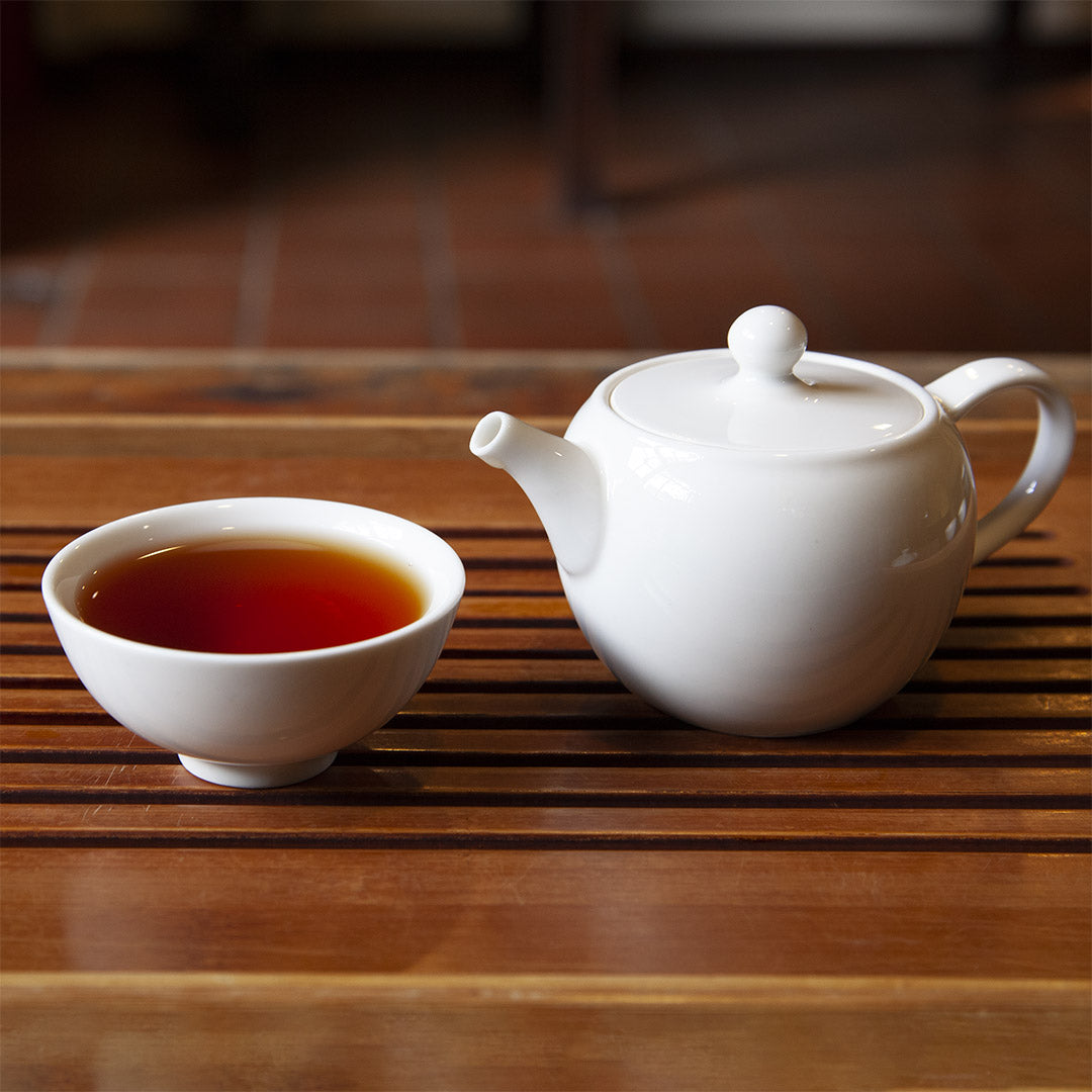 White porcelain tea cup with teapot