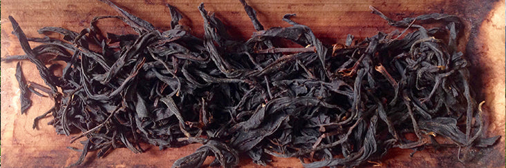 Eco-Cha Teas Organic Wuyi Black Tea on a bamboo tea scoop