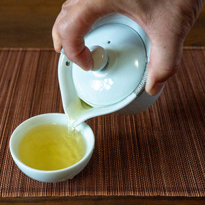 Gaiwan Pitcher with Handles pouring tea into a cup