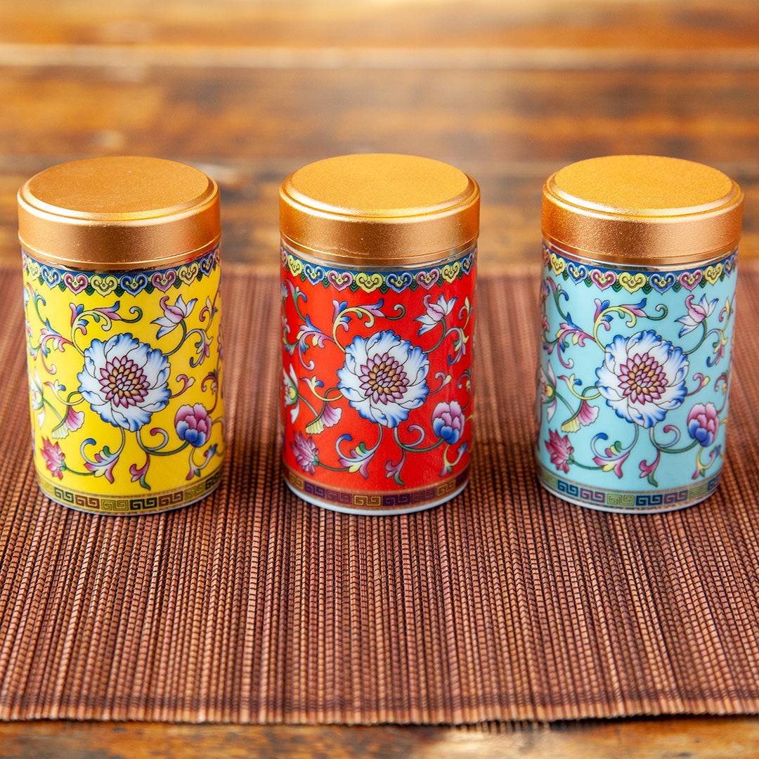 Portable ceramic tea caddy in yellow, red, and blue colors