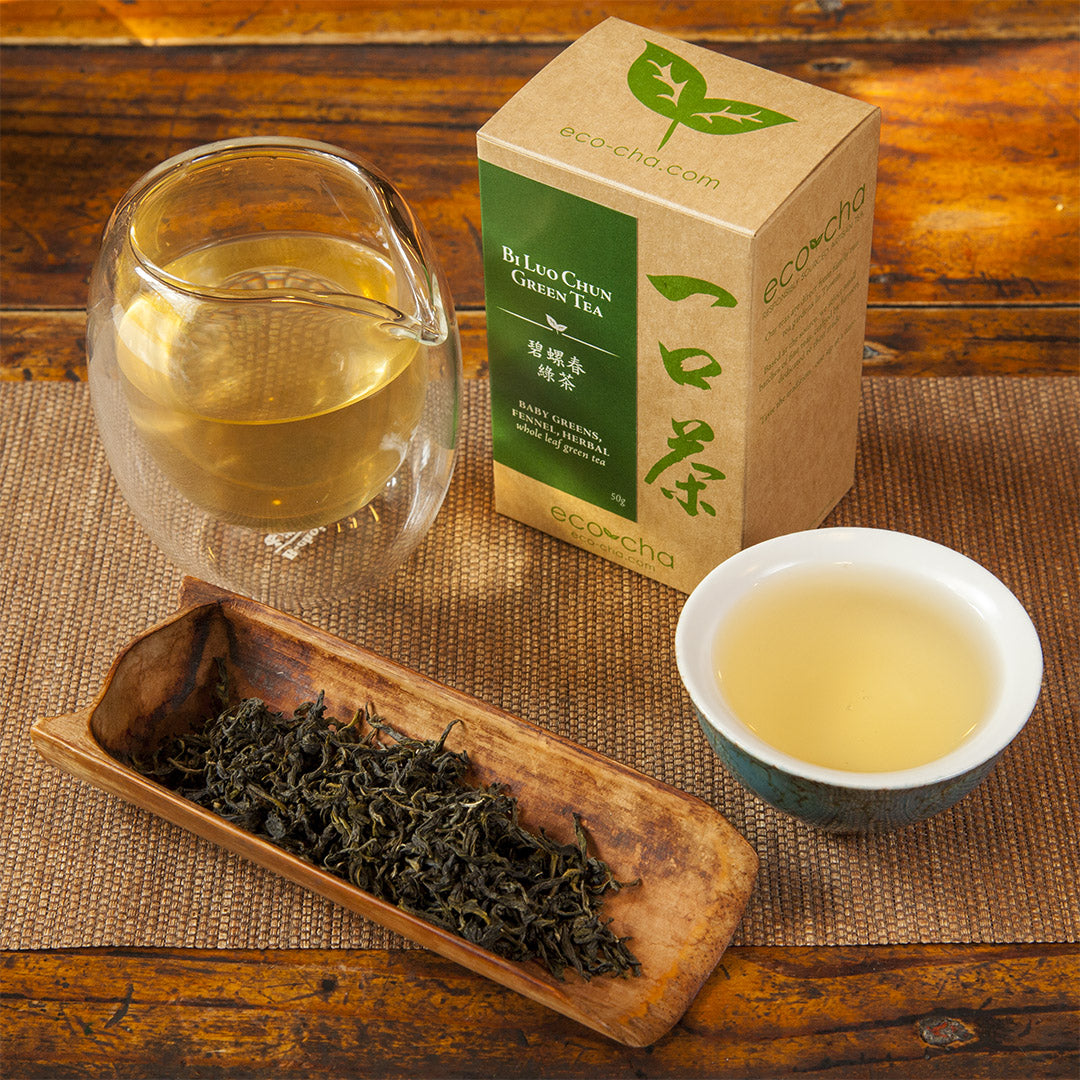 Bi Luo Chun Green Tea dry leaves and brewed in teacup with packaging