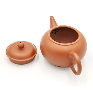 Clay teapot with lid off and seeing inside
