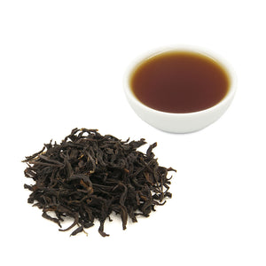 Eco-Farmed Four Seasons Spring Black Tea, dry leaves and brewed tea in white ceramic cup - Eco-Cha Teas