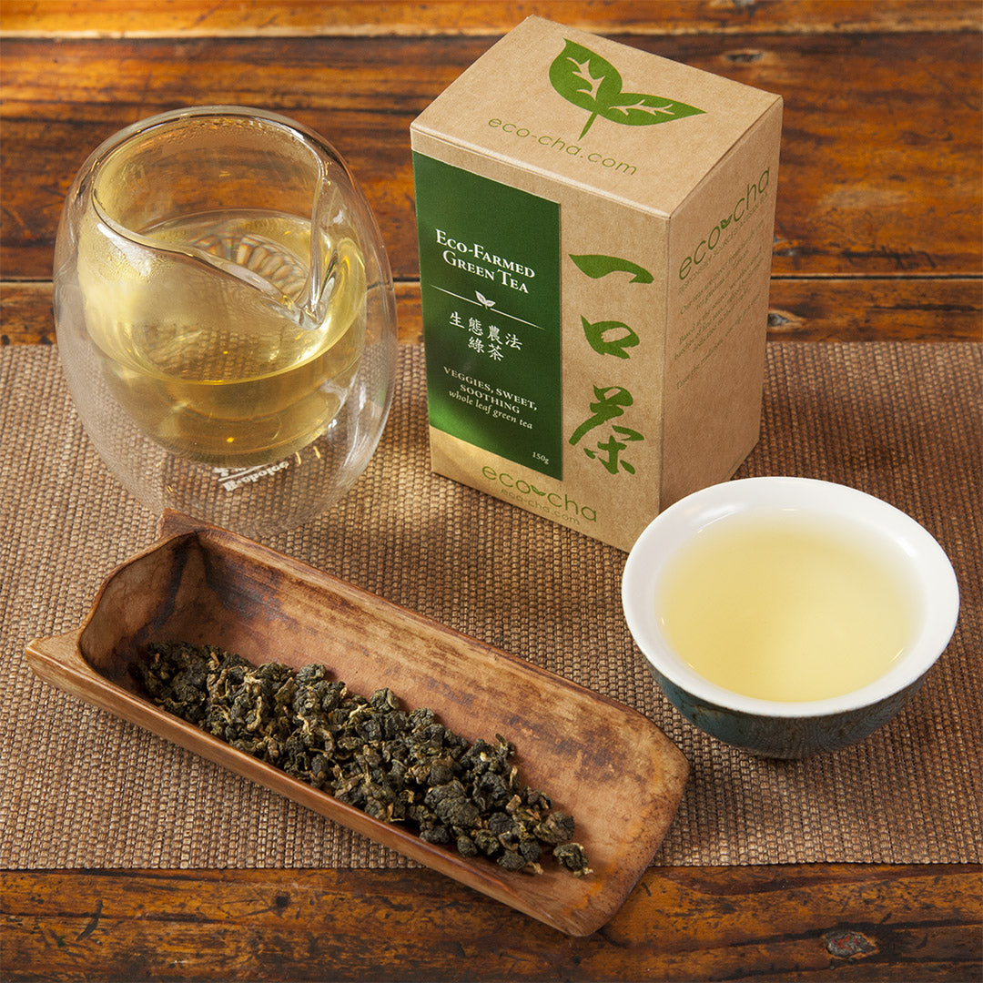 Eco-Farmed Green Tea leaves and brewed tea with packaging