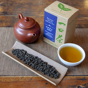 Roasted Tsui Yu Oolong Tea on table with teapot and package box