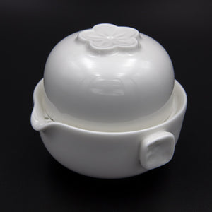 White porcelain single brew teapot and tea cup