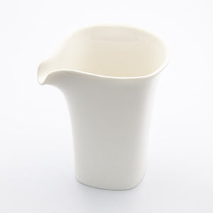 White porcelain tea pitcher on white background